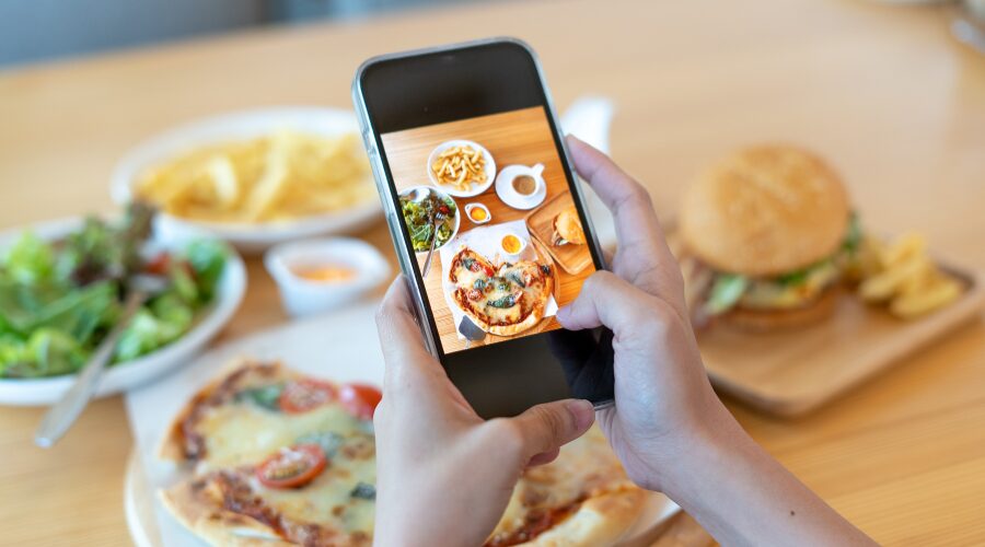 social media marketing image of woman taking pictures of food